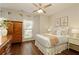 Cozy bedroom with hardwood floors, a ceiling fan, natural light, and tasteful decor at 239 S Village Sq, Canton, GA 30115