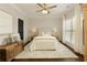 Light and airy bedroom featuring a ceiling fan, and a wooden accent chest at 239 S Village Sq, Canton, GA 30115