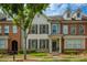 Charming townhome with a well-manicured lawn and a mix of brick and siding facade at 239 S Village Sq, Canton, GA 30115