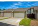 A close up of a garage showing two garage doors, with a nice grass and rock lawn area at 239 S Village Sq, Canton, GA 30115