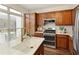 Modern kitchen with stainless steel appliances, granite counters, and ample cabinet space at 239 S Village Sq, Canton, GA 30115