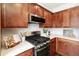 Bright kitchen features stainless steel appliances, white countertops, and warm wood cabinets at 239 S Village Sq, Canton, GA 30115