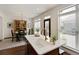 Bright kitchen boasts a center island with sink, dining nook and multiple windows at 239 S Village Sq, Canton, GA 30115