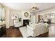 Elegant living room with a fireplace, hardwood floors, and lots of natural light at 239 S Village Sq, Canton, GA 30115