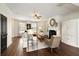 Bright and airy living room featuring a fireplace, white built-ins and hardwood floors at 239 S Village Sq, Canton, GA 30115