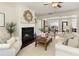 Bright and open living room with fireplace, hardwood floors, and dining area view at 239 S Village Sq, Canton, GA 30115