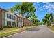 Picturesque neighborhood street with sidewalks lined with trees and beautiful two-story townhouses at 239 S Village Sq, Canton, GA 30115