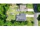 An aerial view of a house with solar panels, a large yard, and mature trees in a quiet neighborhood setting at 2804 Skyland Ne Dr, Brookhaven, GA 30341