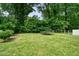 A spacious backyard with a trampoline and surrounded by mature trees and landscaping at 2804 Skyland Ne Dr, Brookhaven, GA 30341