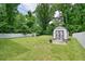 Spacious backyard with a lush lawn, white fence, and a shed for extra storage at 2804 Skyland Ne Dr, Brookhaven, GA 30341