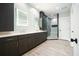 Bathroom with double vanity, tiled shower, hardwood floors, and LED mirrors at 2804 Skyland Ne Dr, Brookhaven, GA 30341
