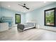 Light-filled bedroom with two large windows, modern ceiling fan, and stylish decor at 2804 Skyland Ne Dr, Brookhaven, GA 30341