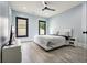 Bedroom featuring luxury vinyl floors, a ceiling fan, and a modern aesthetic with light blue walls at 2804 Skyland Ne Dr, Brookhaven, GA 30341