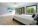 Bedroom features modern ceiling fan, large windows and tv at 2804 Skyland Ne Dr, Brookhaven, GA 30341