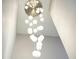 Stairwell with a modern chandelier featuring multiple globe lights, creating an elegant look at 2804 Skyland Ne Dr, Brookhaven, GA 30341