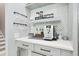 A coffee bar featuring a modern coffee machine, mosaic tile backsplash, and elegant glass racks at 2804 Skyland Ne Dr, Brookhaven, GA 30341