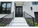 Close up of the front entrance to the home, showing black metal railings and an attractive double door at 2804 Skyland Ne Dr, Brookhaven, GA 30341