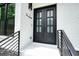 Close up of the elegant front double door, framed by dark railings and a white brick facade at 2804 Skyland Ne Dr, Brookhaven, GA 30341
