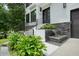 Elegant home entrance with stone accents, a charming water feature, and sleek black metal railings at 2804 Skyland Ne Dr, Brookhaven, GA 30341