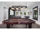 Billiard room features dark wood floors, a custom pool table light, and open layout at 2804 Skyland Ne Dr, Brookhaven, GA 30341