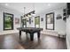 Game room features a billiard table, dark wood floors, and natural light at 2804 Skyland Ne Dr, Brookhaven, GA 30341