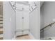 Hallway with modern staircase, coat hooks, and a built-in storage cabinet with lower drawers at 2804 Skyland Ne Dr, Brookhaven, GA 30341