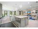 Open concept kitchen and living room featuring a large island, fireplace and suspended bubble chairs at 2804 Skyland Ne Dr, Brookhaven, GA 30341