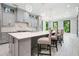 Open kitchen with gray cabinets, stainless appliances, quartz countertops, and a large island with bar stool seating at 2804 Skyland Ne Dr, Brookhaven, GA 30341