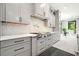 Spacious kitchen with gray cabinets, stainless steel range, quartz countertops, and decorative tile backsplash at 2804 Skyland Ne Dr, Brookhaven, GA 30341