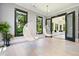 Sunlit living room featuring suspended bubble chairs and a view to an adjacent sunroom at 2804 Skyland Ne Dr, Brookhaven, GA 30341