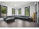 Living room with a large leather sectional couch, wood floors, and abundant natural light at 2804 Skyland Ne Dr, Brookhaven, GA 30341