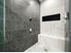 Modern tiled shower features two shower heads and shower bench at 2804 Skyland Ne Dr, Brookhaven, GA 30341