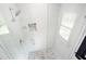 All-white tiled shower features rain-style shower head and mosaic floor and niche at 2804 Skyland Ne Dr, Brookhaven, GA 30341