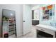 Well-organized walk-in closet leading to bathroom vanity with illuminated mirror and open storage at 2804 Skyland Ne Dr, Brookhaven, GA 30341