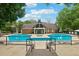 Community pool with a sundeck and lounge chairs surrounded by lush landscaping at 539 Mcgill Park Ne Ave, Atlanta, GA 30312
