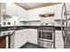 Efficient kitchen with stainless steel appliances, black countertops, and white cabinets at 539 Mcgill Park Ne Ave, Atlanta, GA 30312