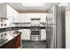 Efficient kitchen with stainless steel appliances, black countertops, and white cabinets at 539 Mcgill Park Ne Ave, Atlanta, GA 30312