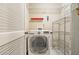 Functional laundry room with a front loading washer/dryer and metal shelving for storage at 539 Mcgill Park Ne Ave, Atlanta, GA 30312