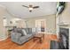 Cozy living room features a fireplace, ceiling fan, and open floor plan at 539 Mcgill Park Ne Ave, Atlanta, GA 30312