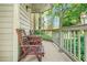 Exterior shot of a covered porch featuring two wooden chairs, a table, and a pleasant view at 539 Mcgill Park Ne Ave, Atlanta, GA 30312