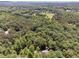 A sprawling, wooded landscape with a private home, and lush greenery at 6960 Worley Rd, Cumming, GA 30028