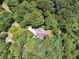 The property is located on large plot with driveway access and surrounded by trees at 6960 Worley Rd, Cumming, GA 30028