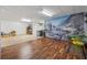 Large basement with wood-look floor and mural, suitable for recreation or storage at 6960 Worley Rd, Cumming, GA 30028