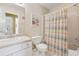 Clean bathroom with vanity, toilet, and shower-tub combination enclosed by a stylish curtain, offering daily convenience at 6960 Worley Rd, Cumming, GA 30028