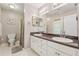 Bright bathroom featuring a double vanity, mirrors, a toilet, and ample lighting at 6960 Worley Rd, Cumming, GA 30028