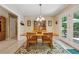 Bright dining room featuring a large table, seating for six, and access to a sun-drenched outdoor patio at 6960 Worley Rd, Cumming, GA 30028