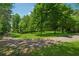 Long driveway leading into a wooded property at 6960 Worley Rd, Cumming, GA 30028