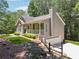 Charming single-story home boasts an attached garage, verdant lawn and professional landscaping at 6960 Worley Rd, Cumming, GA 30028