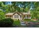 Charming single-story home with a well-manicured lawn, stone walkway, and inviting front porch at 6960 Worley Rd, Cumming, GA 30028