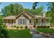 Charming single-story home with a well-manicured lawn, stone walkway, and inviting front porch at 6960 Worley Rd, Cumming, GA 30028